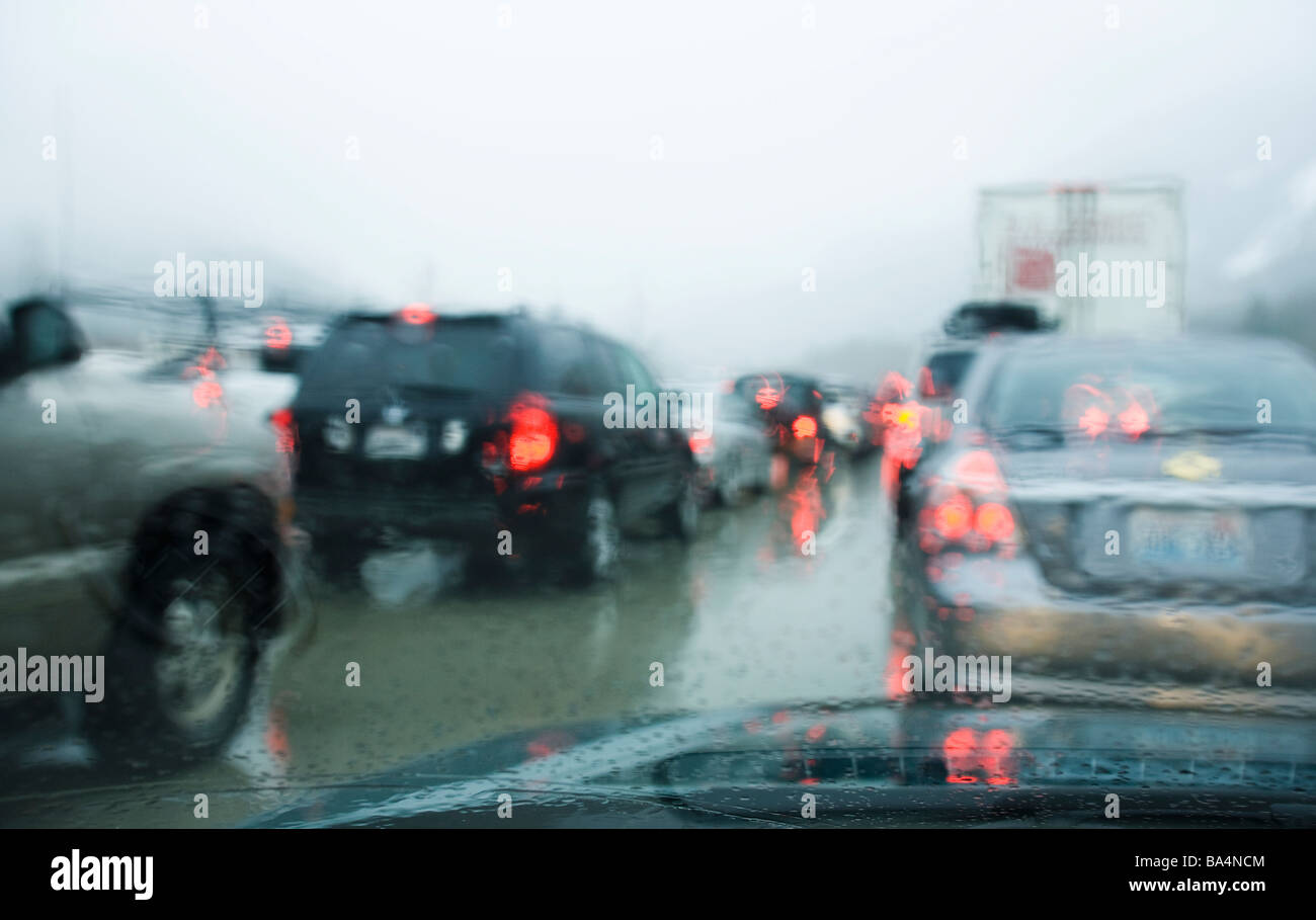 Driving in bumper to bumper traffic through the mountains in a rain snow storm Stock Photo