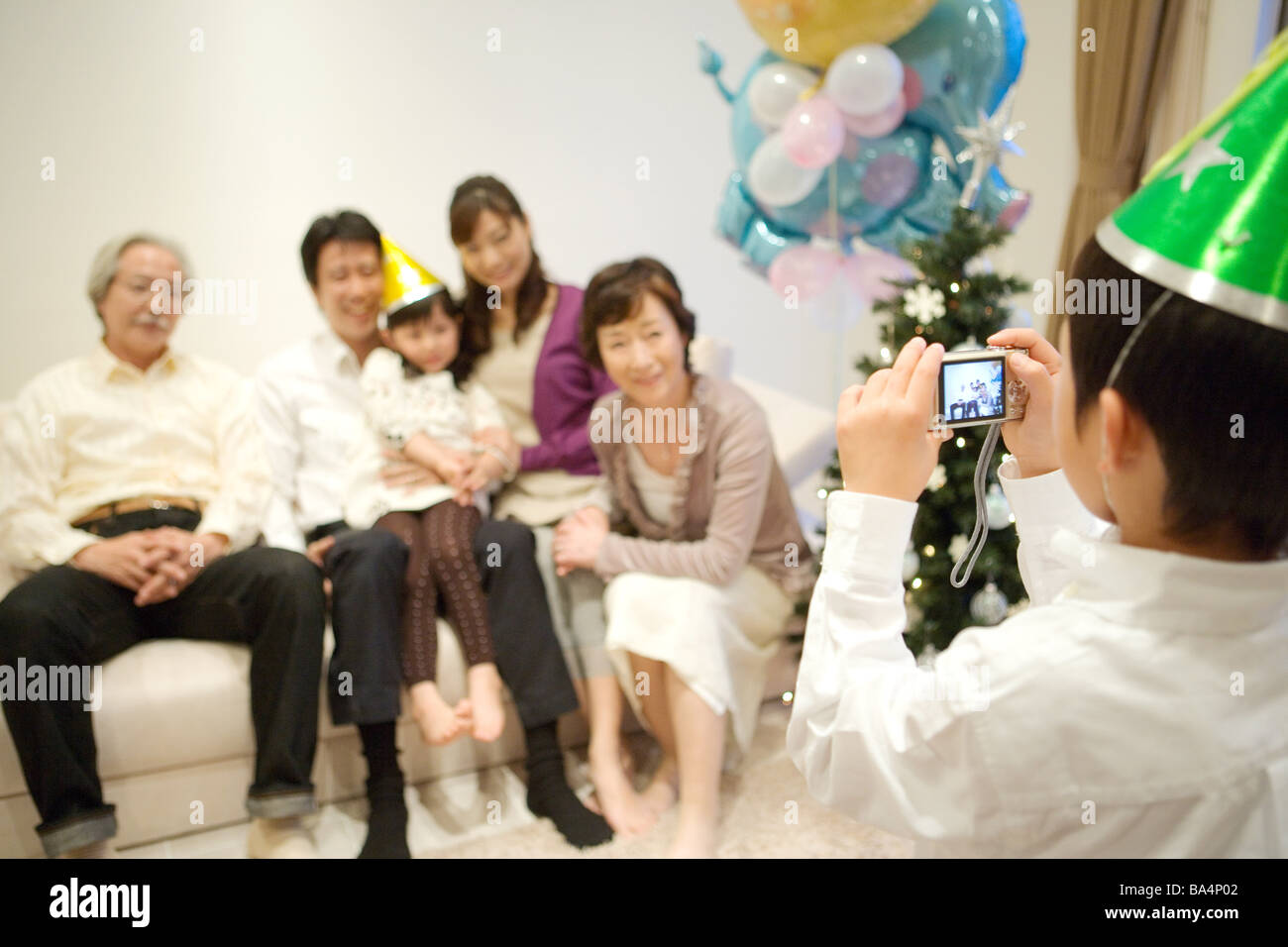 Child taking snap of his family Stock Photo Alamy