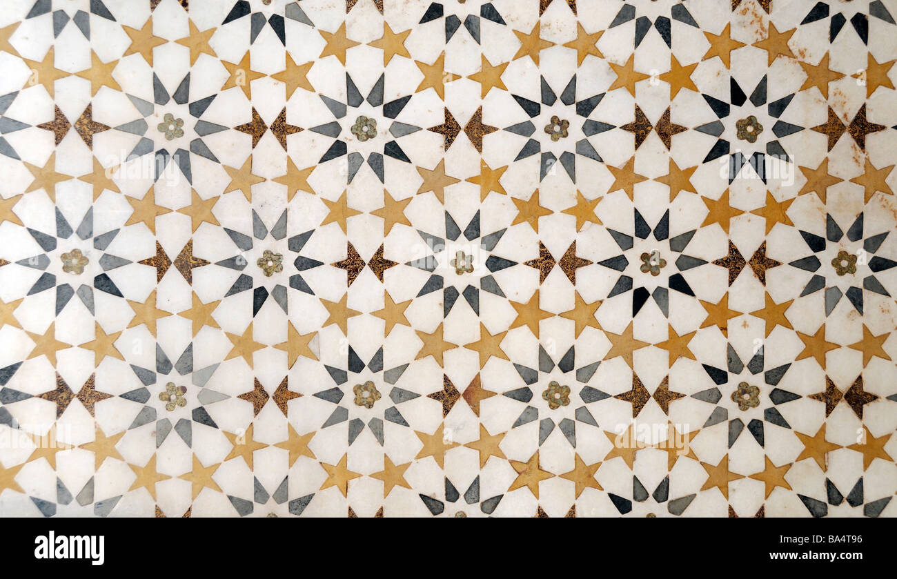 A floor made of a repeating pattern of regular shapes made from semi precious stones inlaid in white marble. Stock Photo