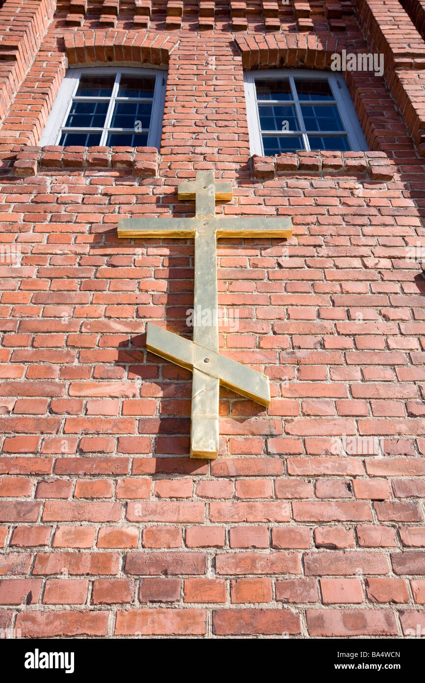 Orthodox Christian cross on red brick wall Stock Photo
