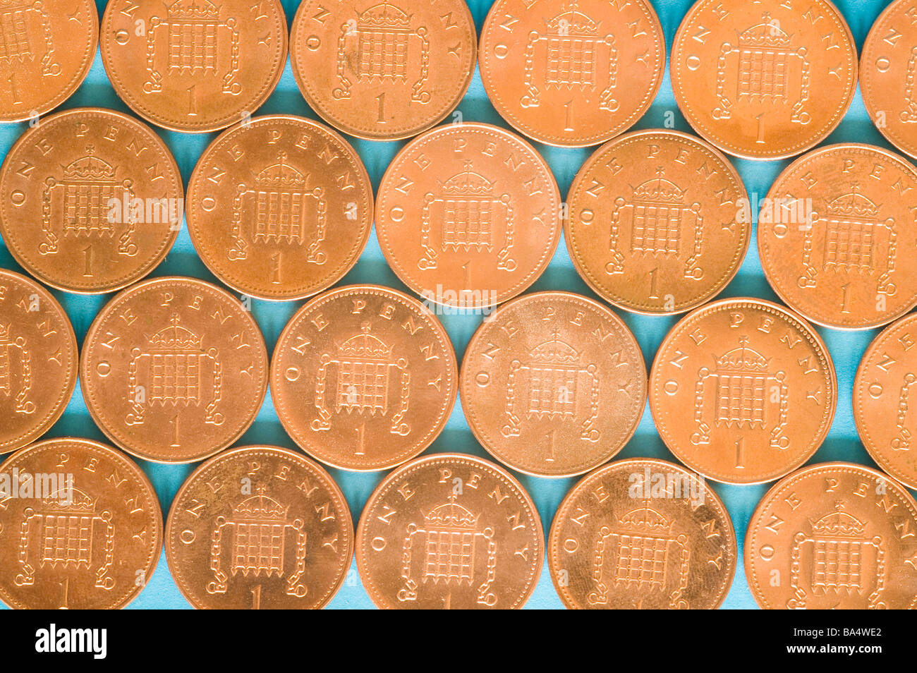Pattern of one pence coins on a light blue background Stock Photo