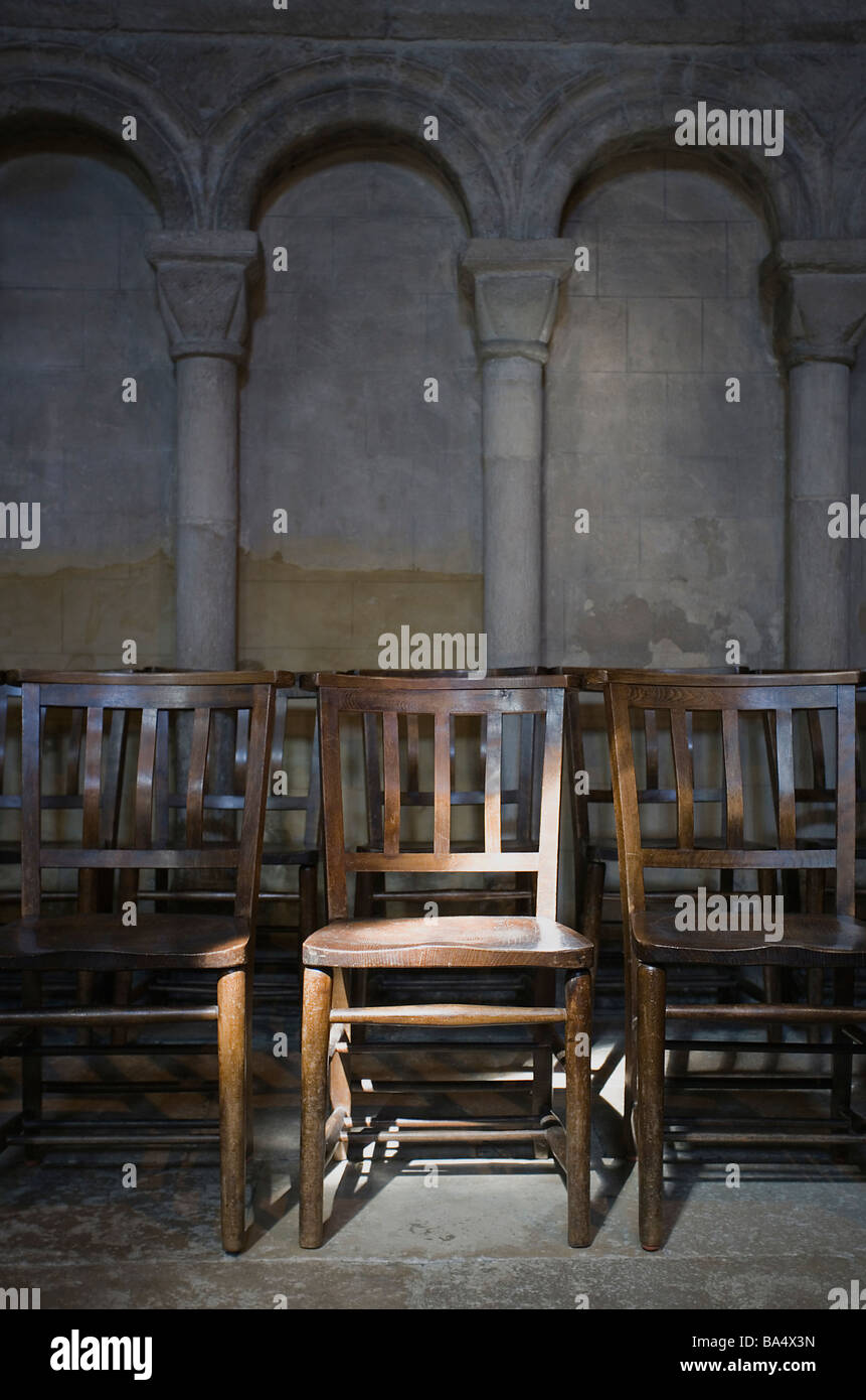 Eery light on rows of chairs in Norwich cathedral Stock Photo