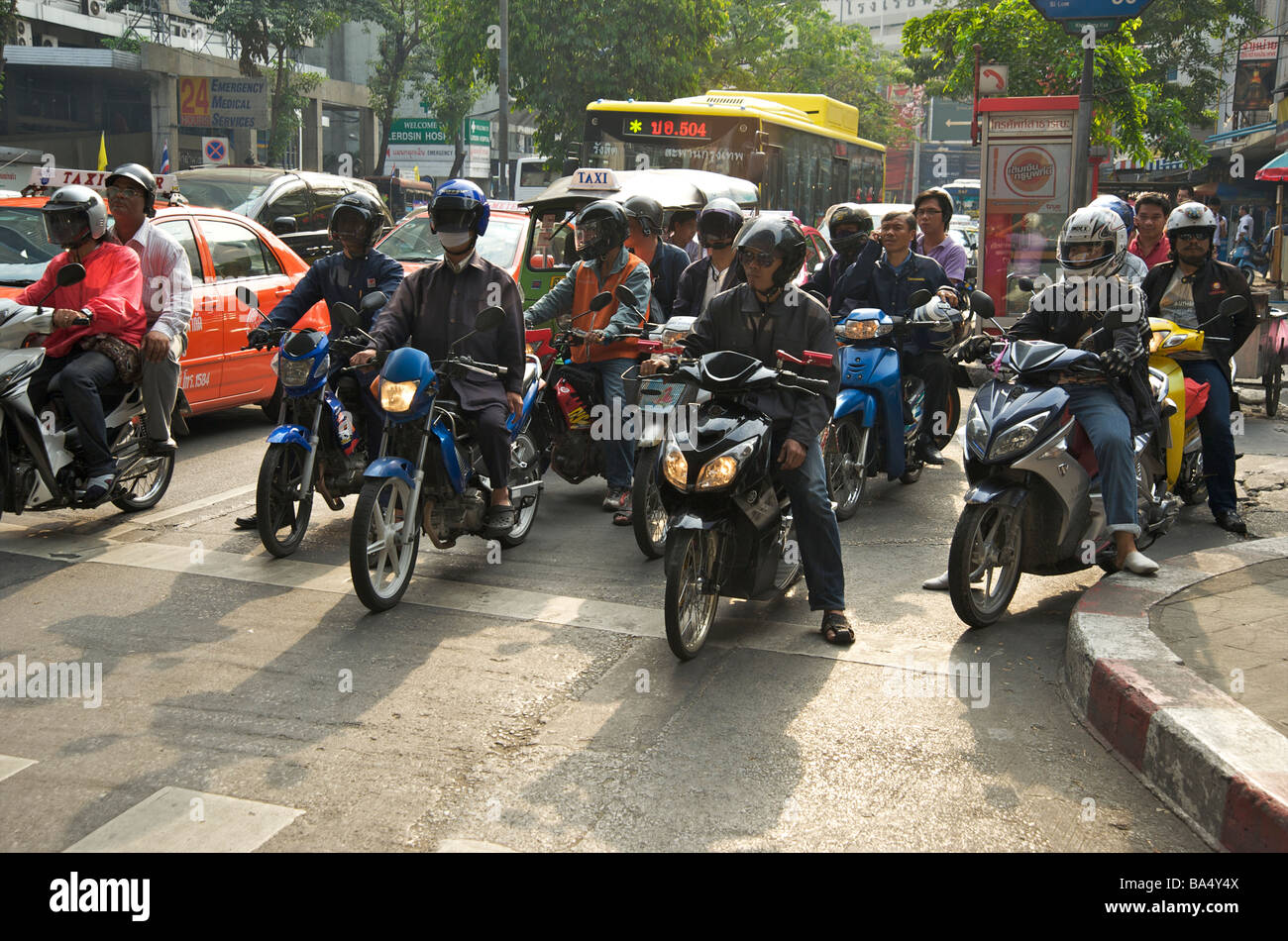 Bangkok mopeds wait at the traffic lights on Silom Road Bangkok Thailand Stock Photo