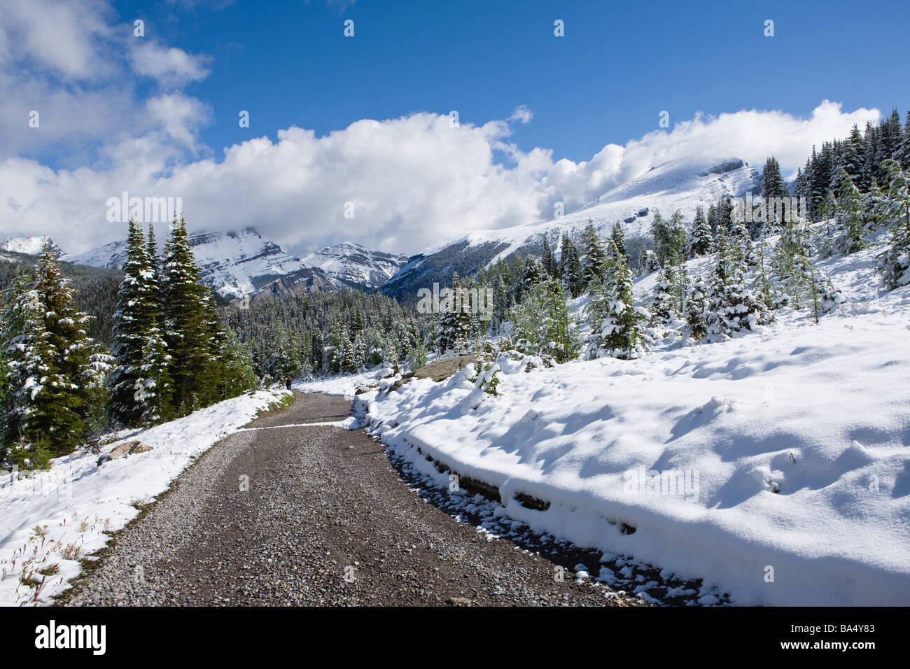 Road Heading From Snow-Capped Mountains Stock Photo