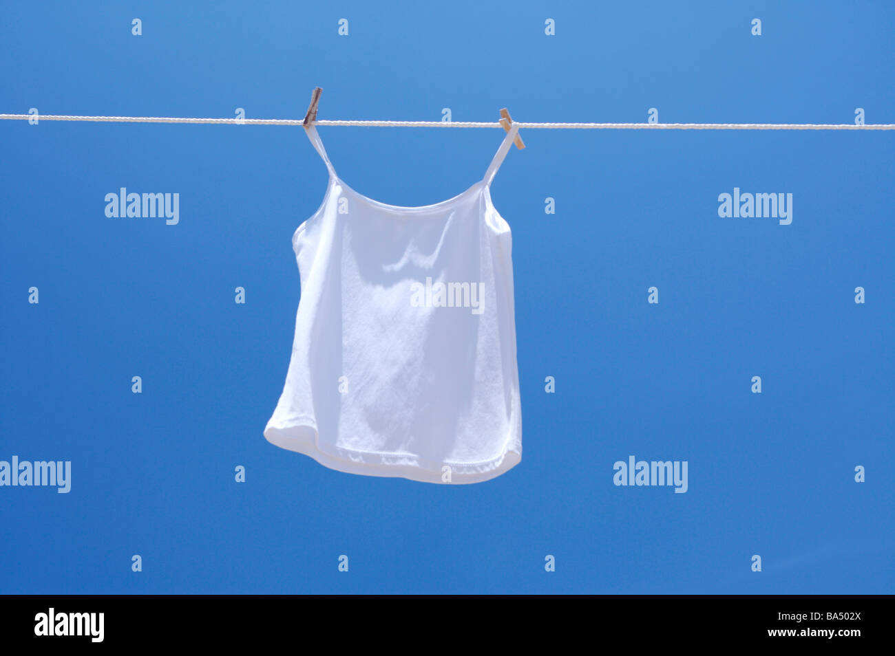 Spaghetti straps hanging on clothesline Stock Photo - Alamy