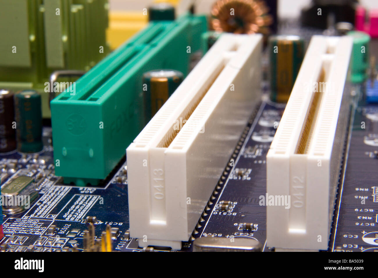 Details of the computer motherboard with PCI and PCI Express slots. Stock Photo