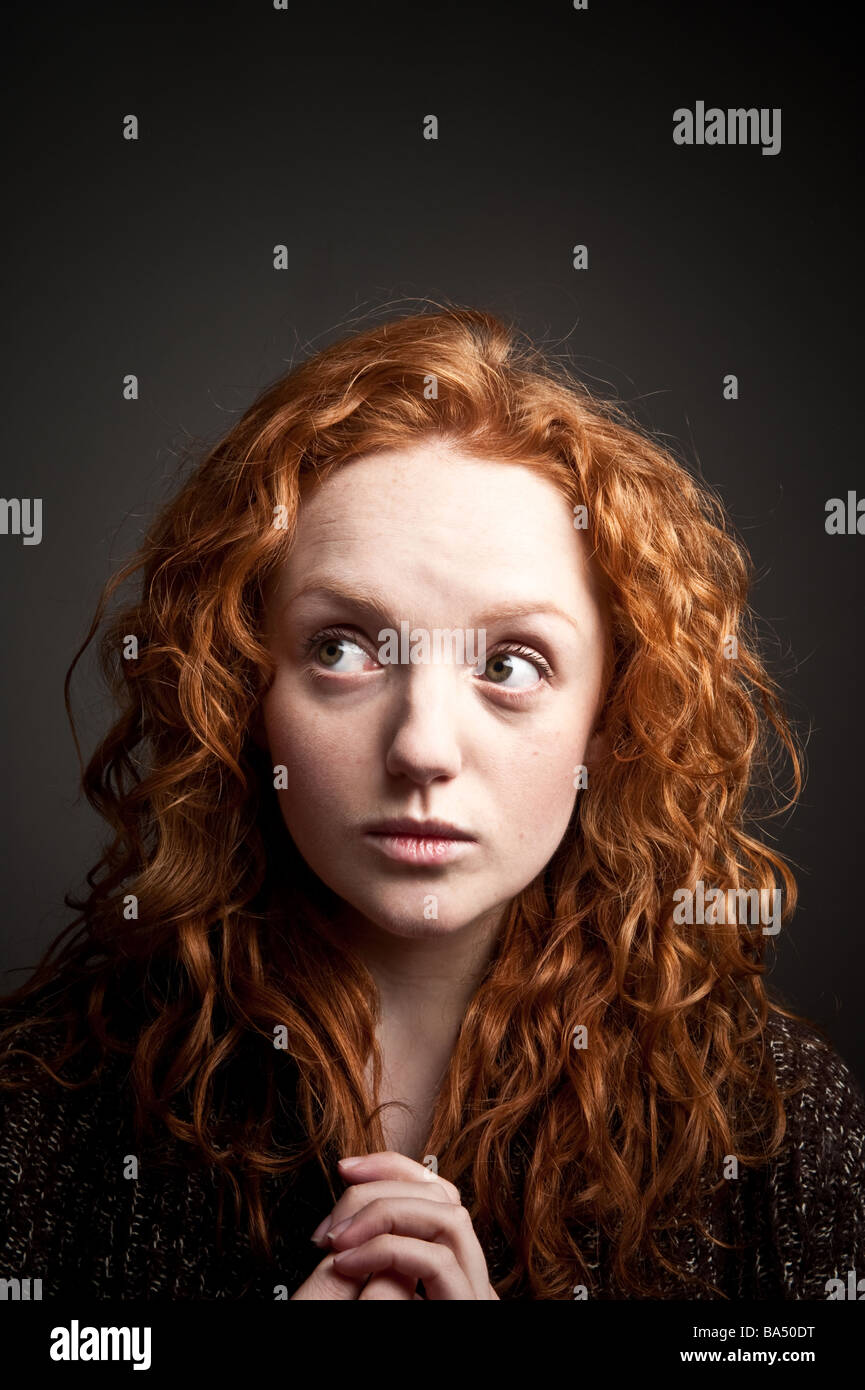 big eyed kooky looking red haired woman girl with long hair Stock Photo