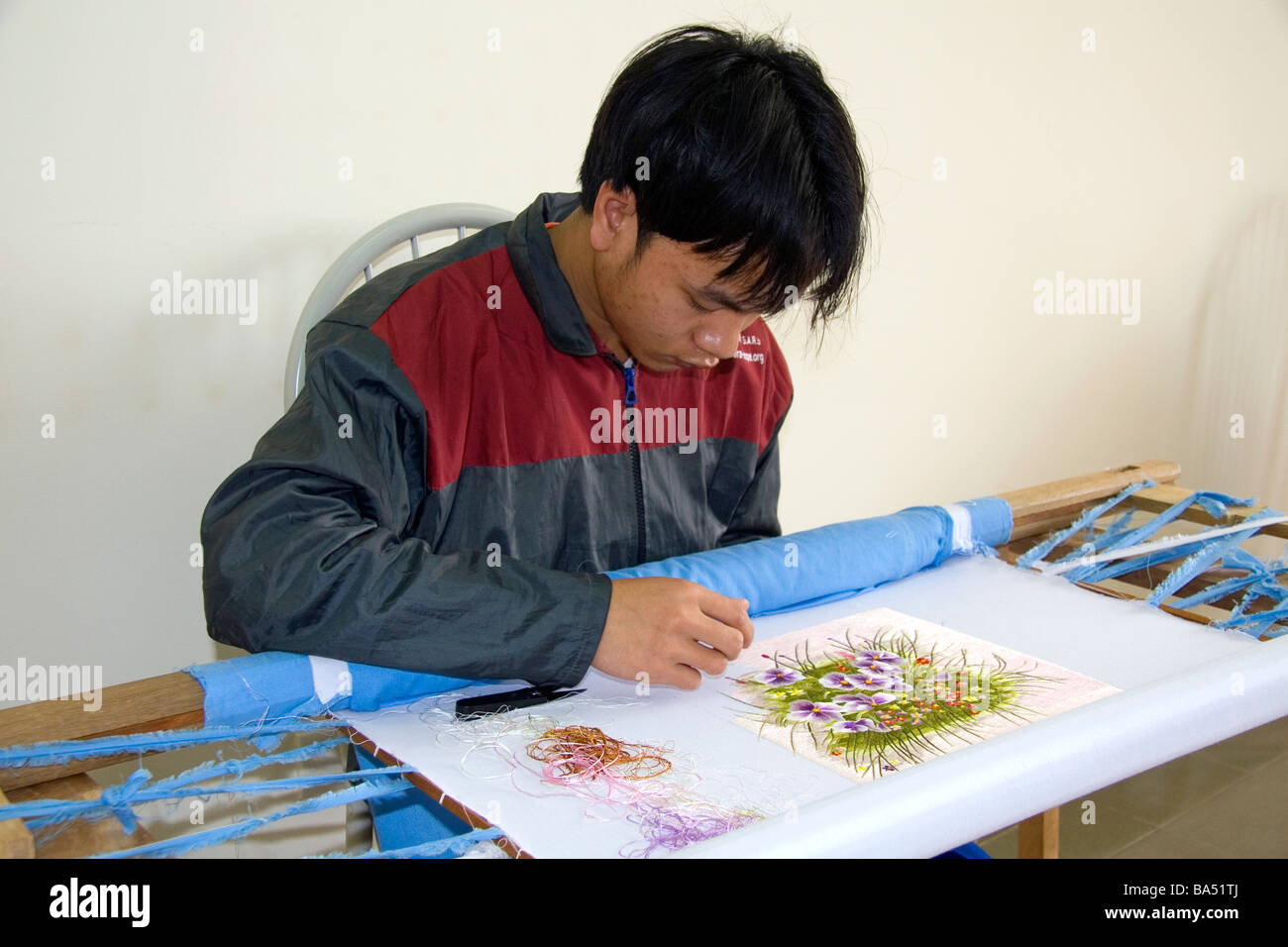 Disadvantaged Vietnamese youth learn embroidery at a vocational school named Kids First Vietnam in Dong Ha Vietman Stock Photo