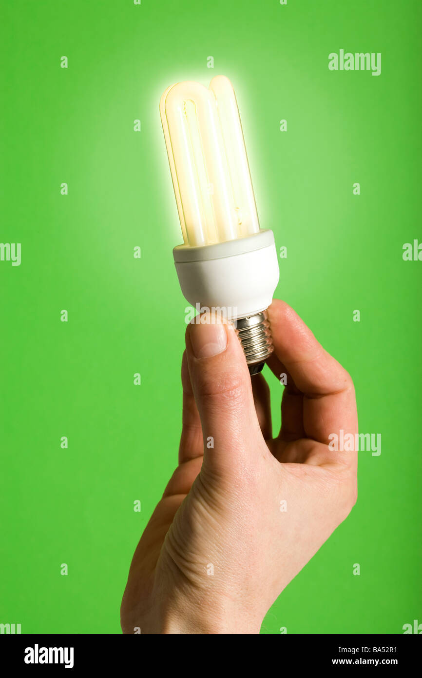 hand holding compact fluorescent lightbulb, no cables attached Stock Photo