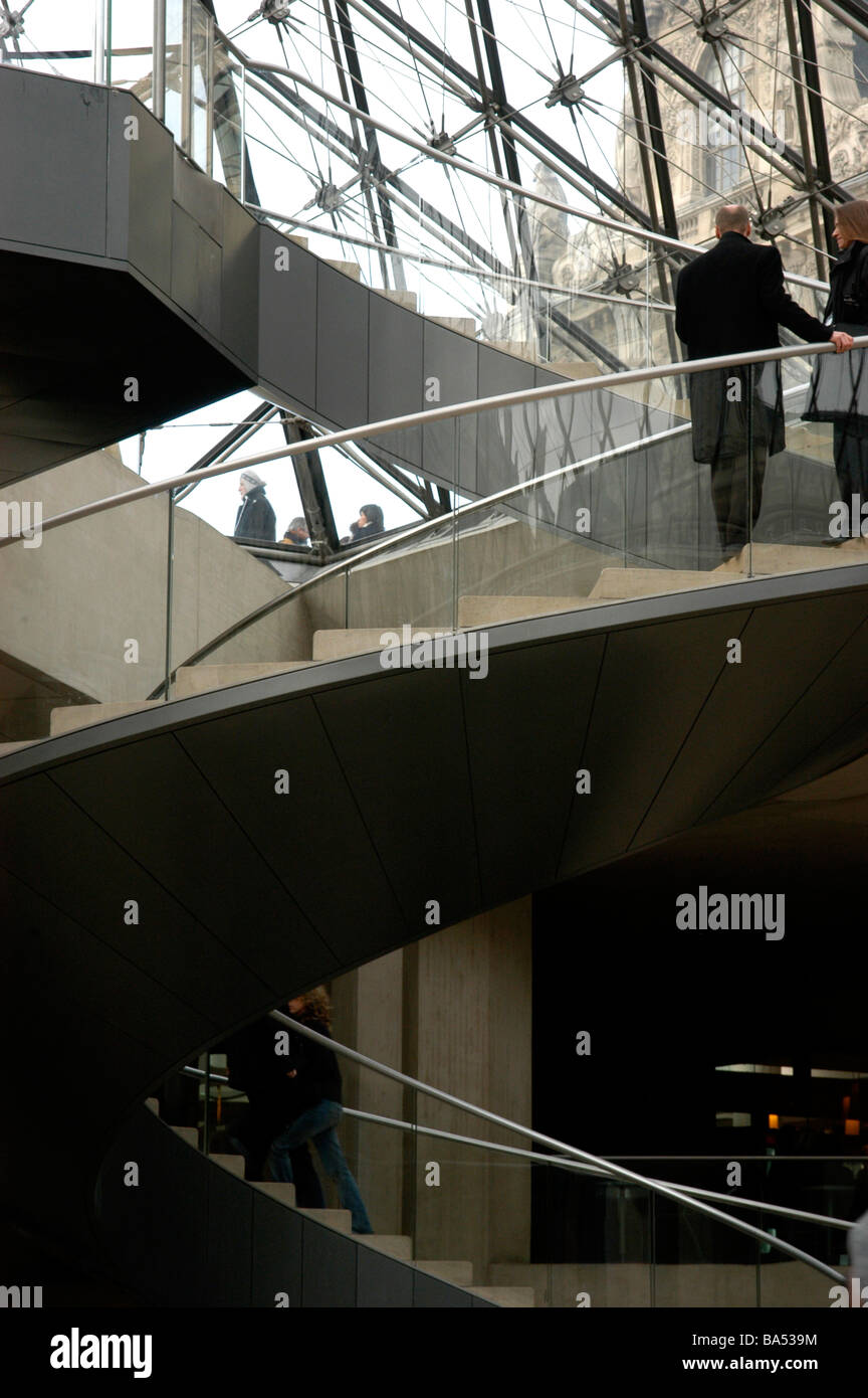 The twisting and curved stairs inside the Louvre Museum in Paris France Stock Photo