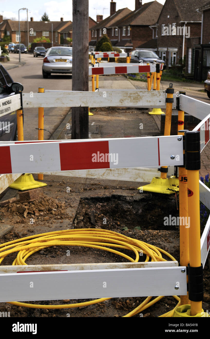 Roadworks replacing gas pipes in suburban residential street UK Stock
