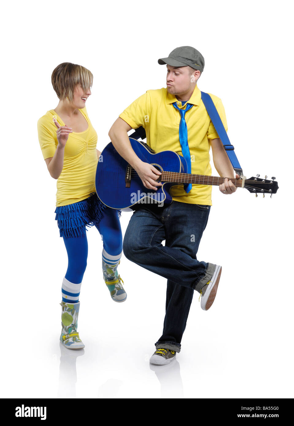 Man playing the guitar and a woman dancing Stock Photo