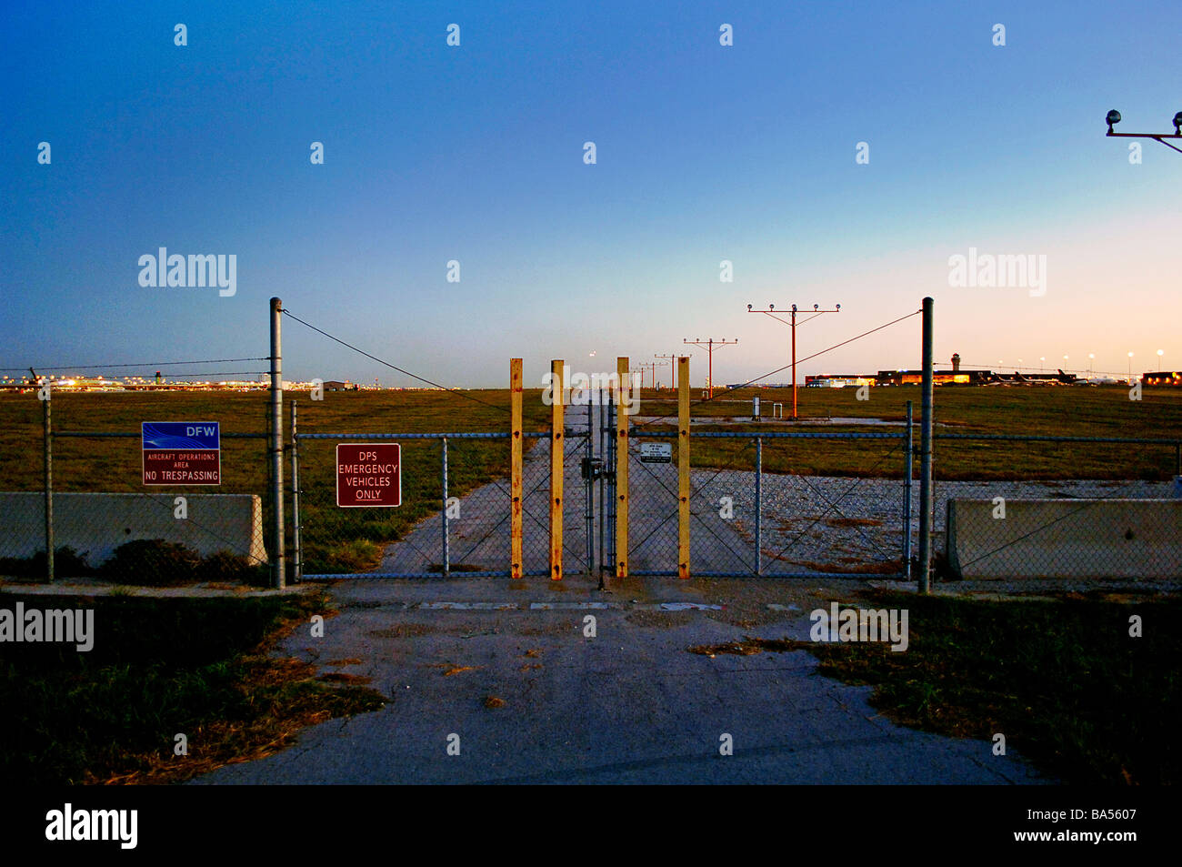 Security gate and runway lights at major international airport, DFW international Stock Photo