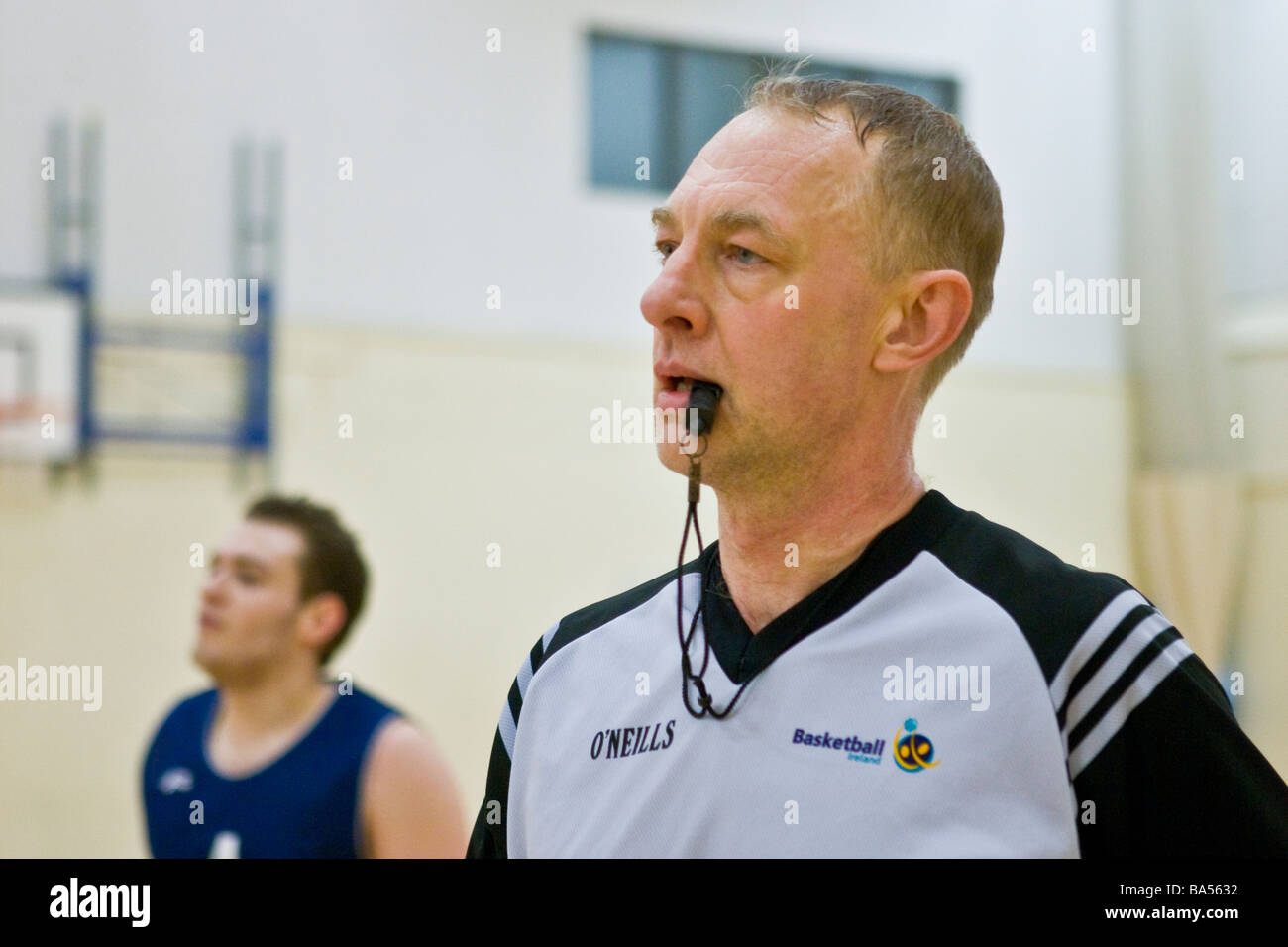 Referee with whistle at basketball match Stock Photo