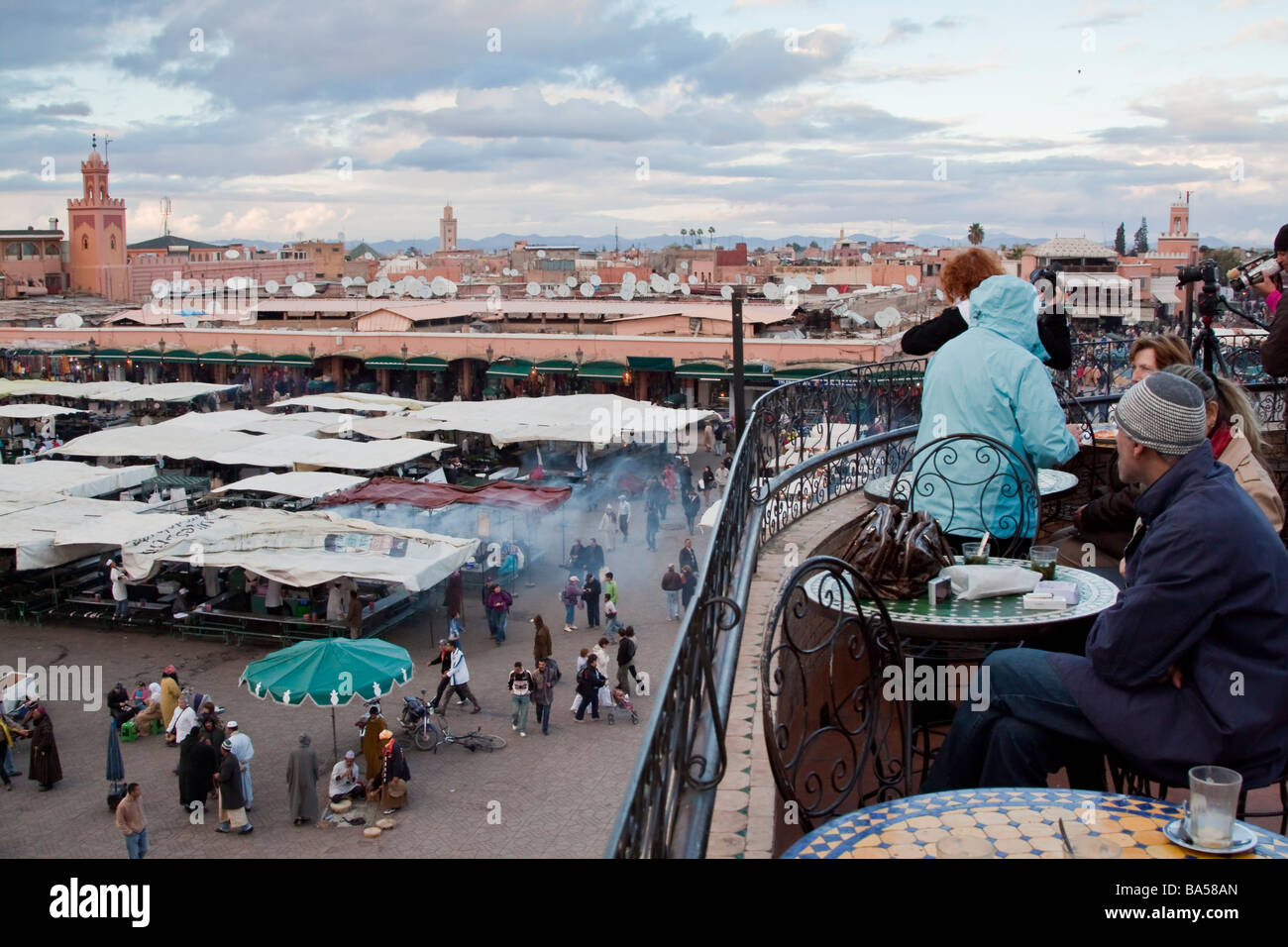 Marrakech Rooftop Tea Tourists relax drinking mint tea from a cafe roof terrace overlooking ...