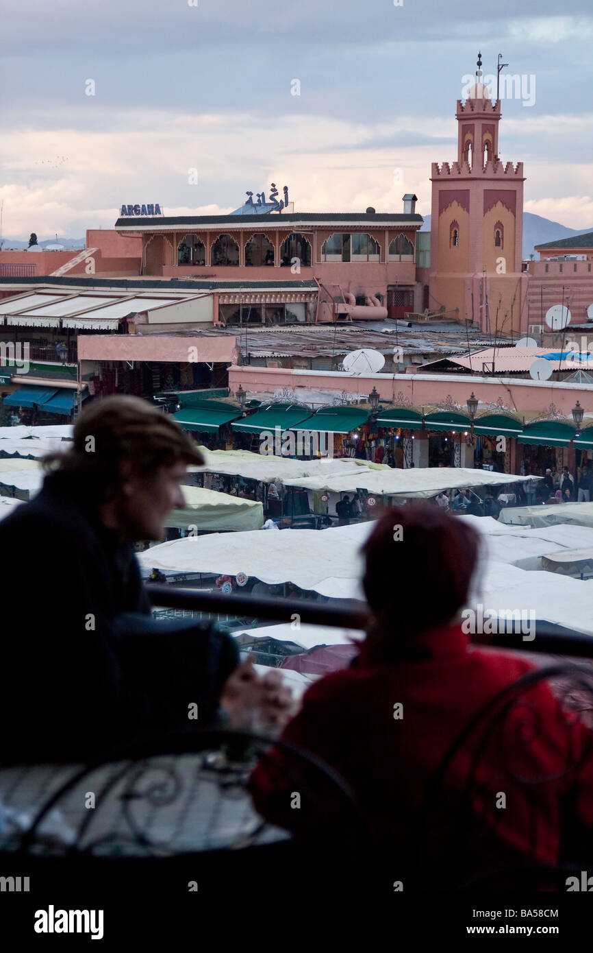Marrakech Rooftop Tea Tourists relax drinking mint tea from a cafe roof terrace overlooking ...