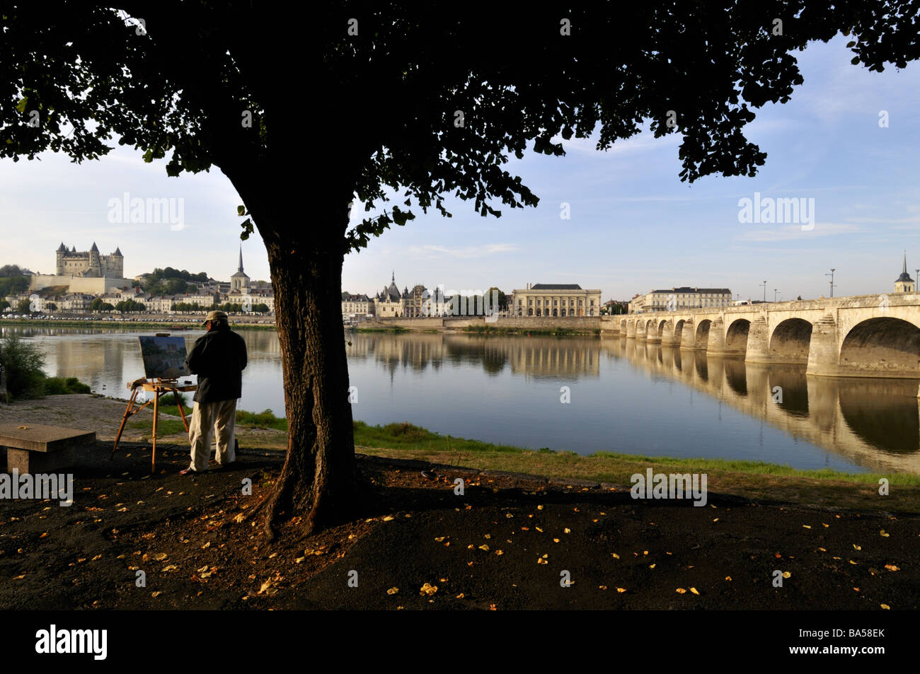 Painter painting by River Loire, Saumur, France. Stock Photo