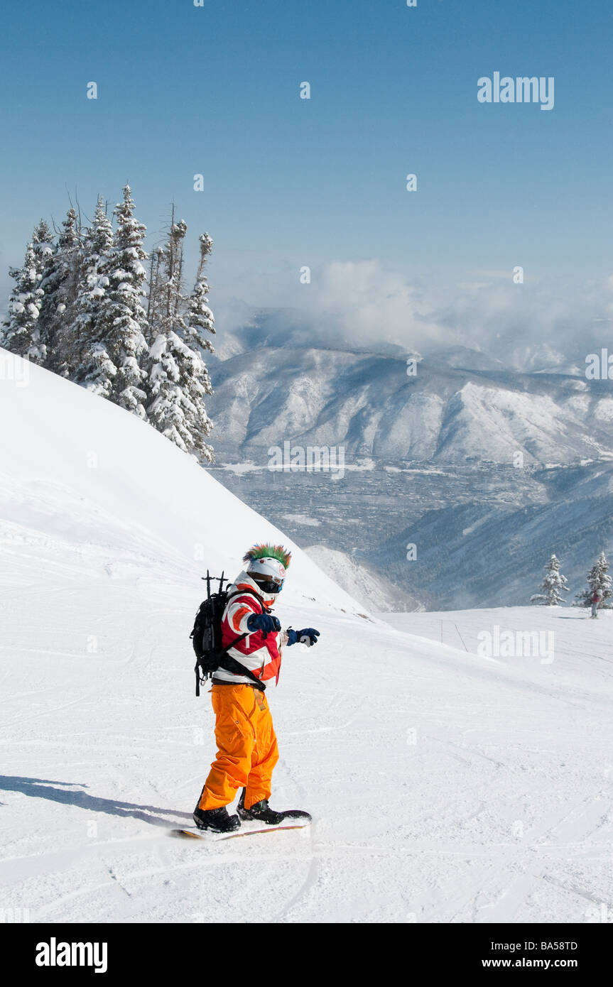 Snowboarder in colorful attire top of the Loge Peak Lift, Aspen Highlands Ski Area, Aspen, Colorado. Stock Photo