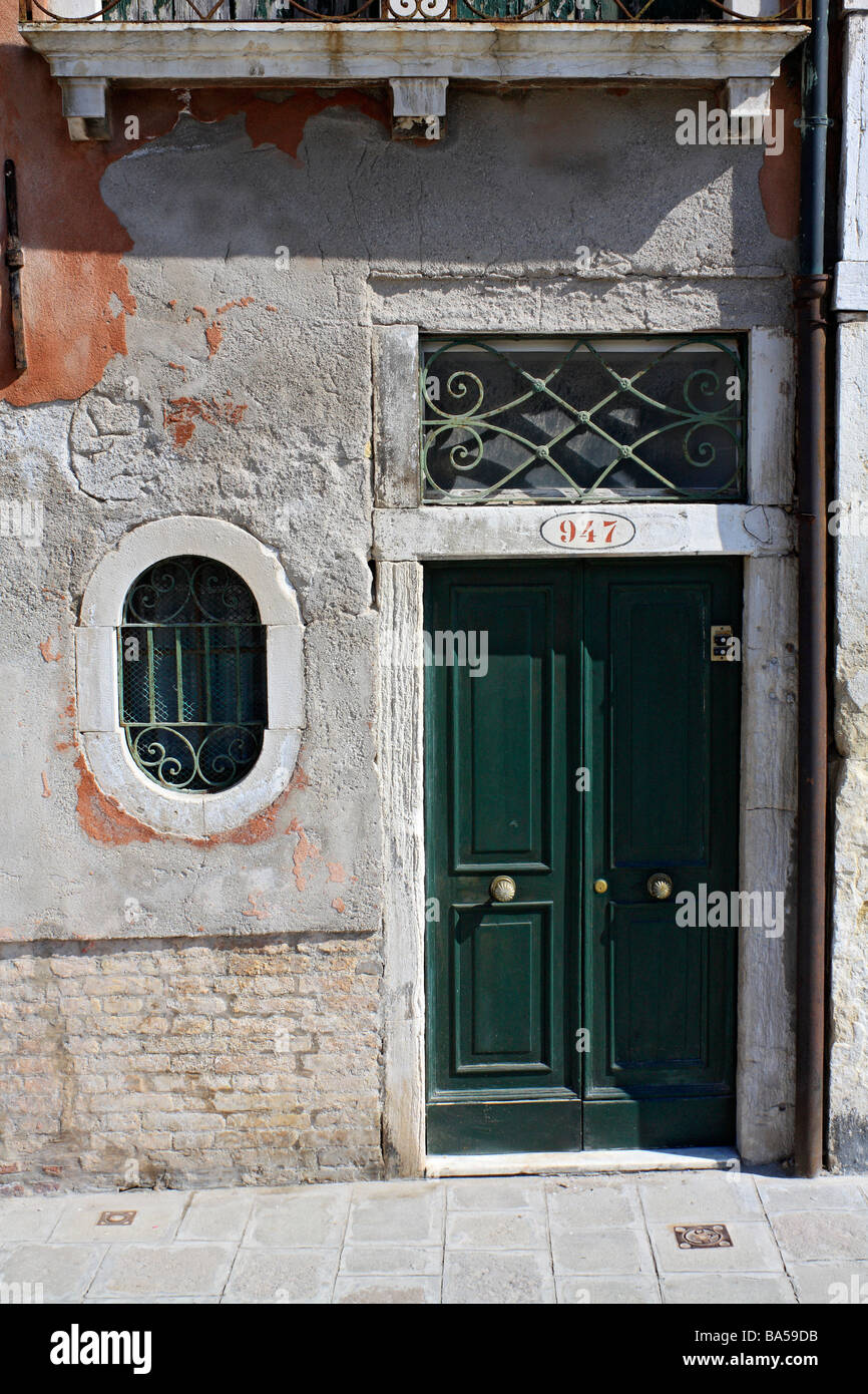 Green Wooden Door Of Apartment Building In Venice Italy Stock