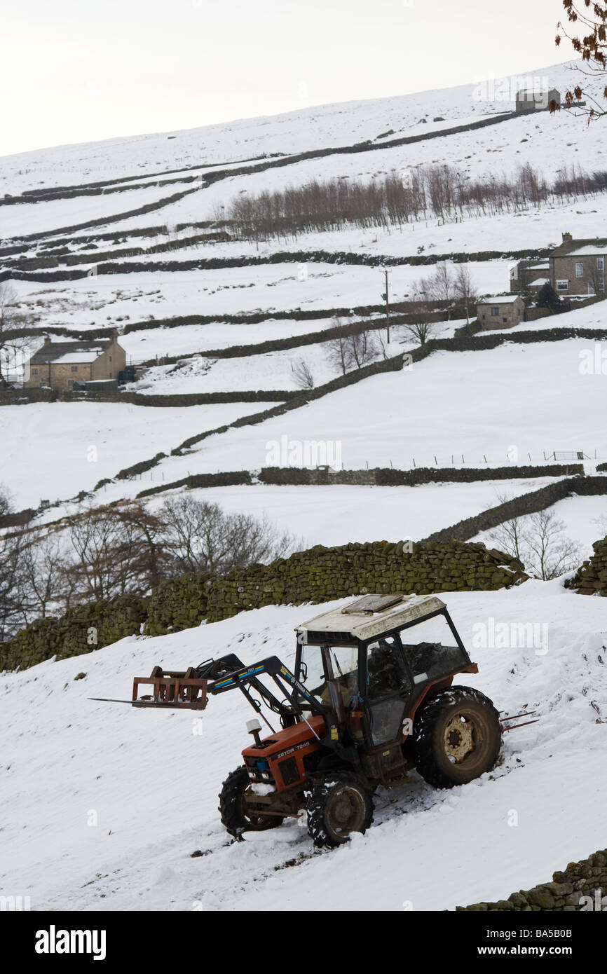 Tractor and snow covered fields near Healaugh in Swaledale North Yorkshire England UK Stock Photo