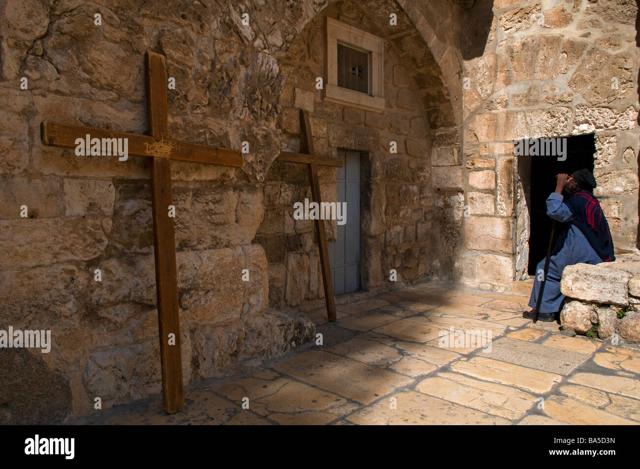 Ethiopian orthodox monk at entrance to the Ethiopian orthodox chamber at the Church of Holy Sepulchre in the Christian Quarter old city East Jerusalem Stock Photo