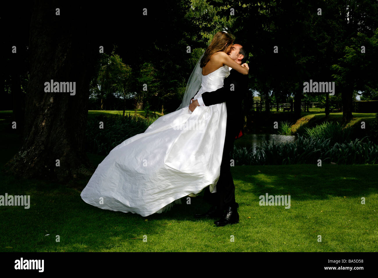 Bride and groom embracing in nature Stock Photo - Alamy