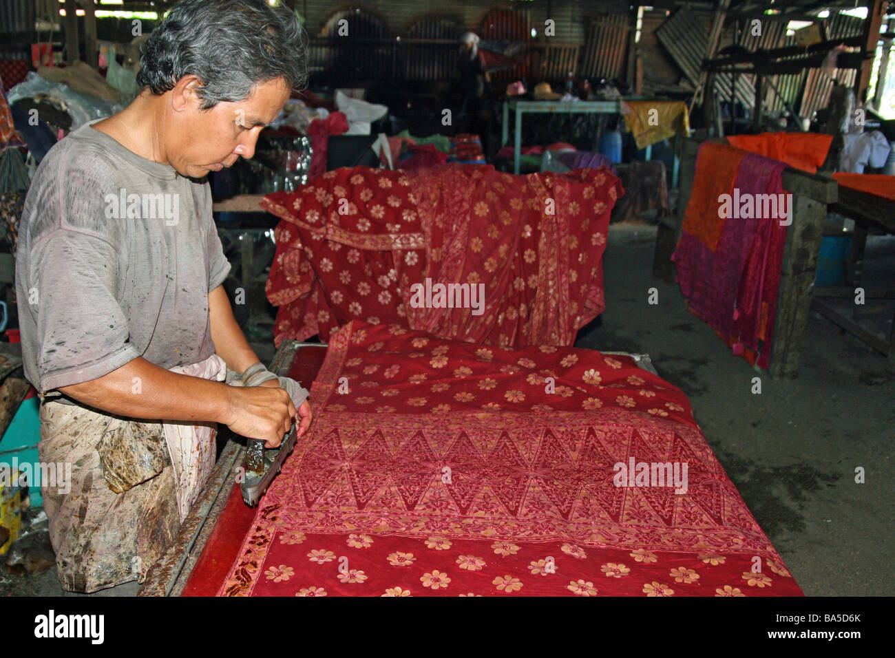Hand-printing batik cloth at a factory in Malaysia Stock Photo