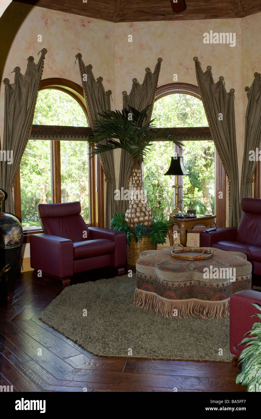 Arched Windows in Round Sitting Room with Octagon Ottoman Stock Photo