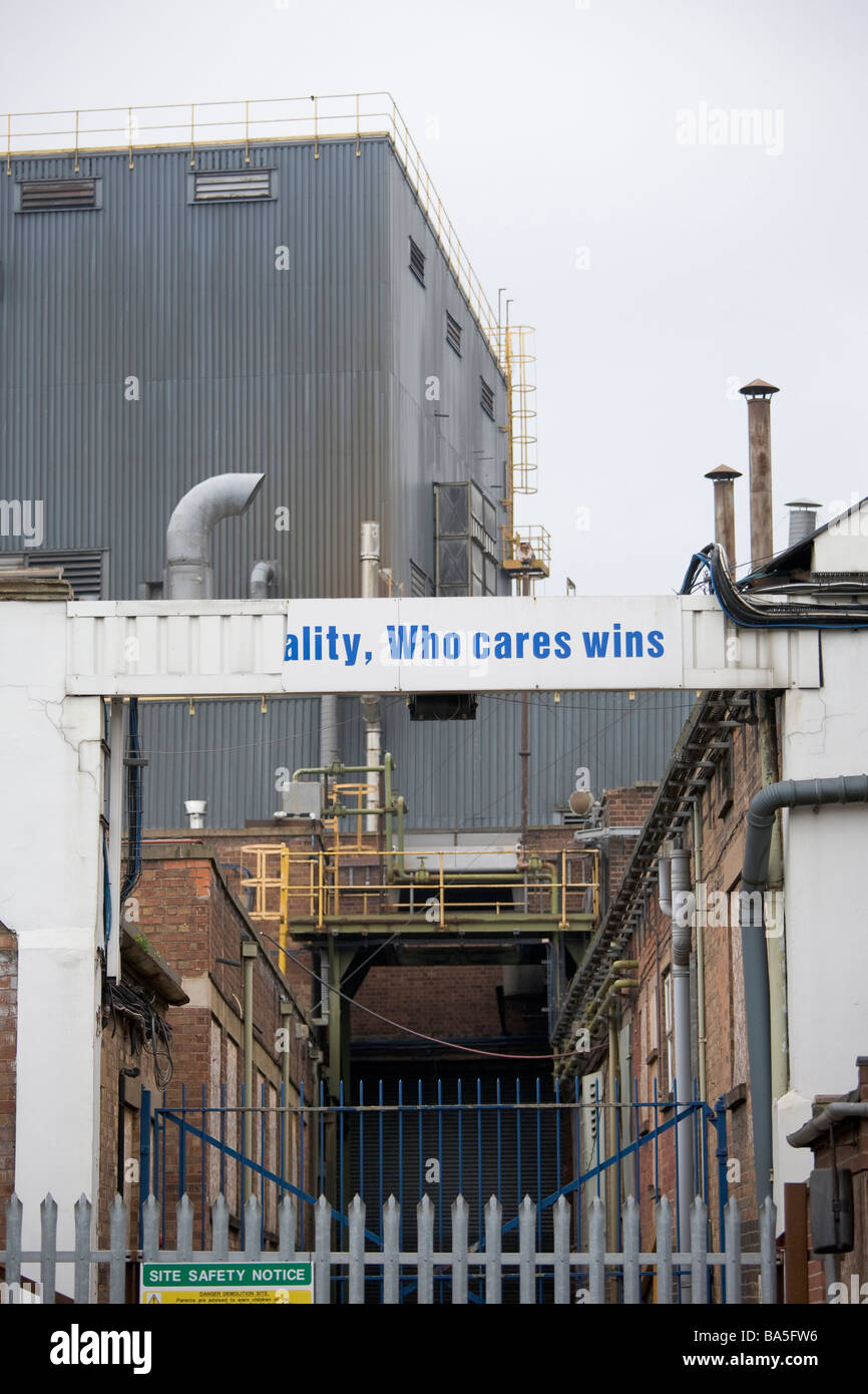 Closed and abandoned Ford factory with a broken 'Quality - Who cares wins' sign Stock Photo