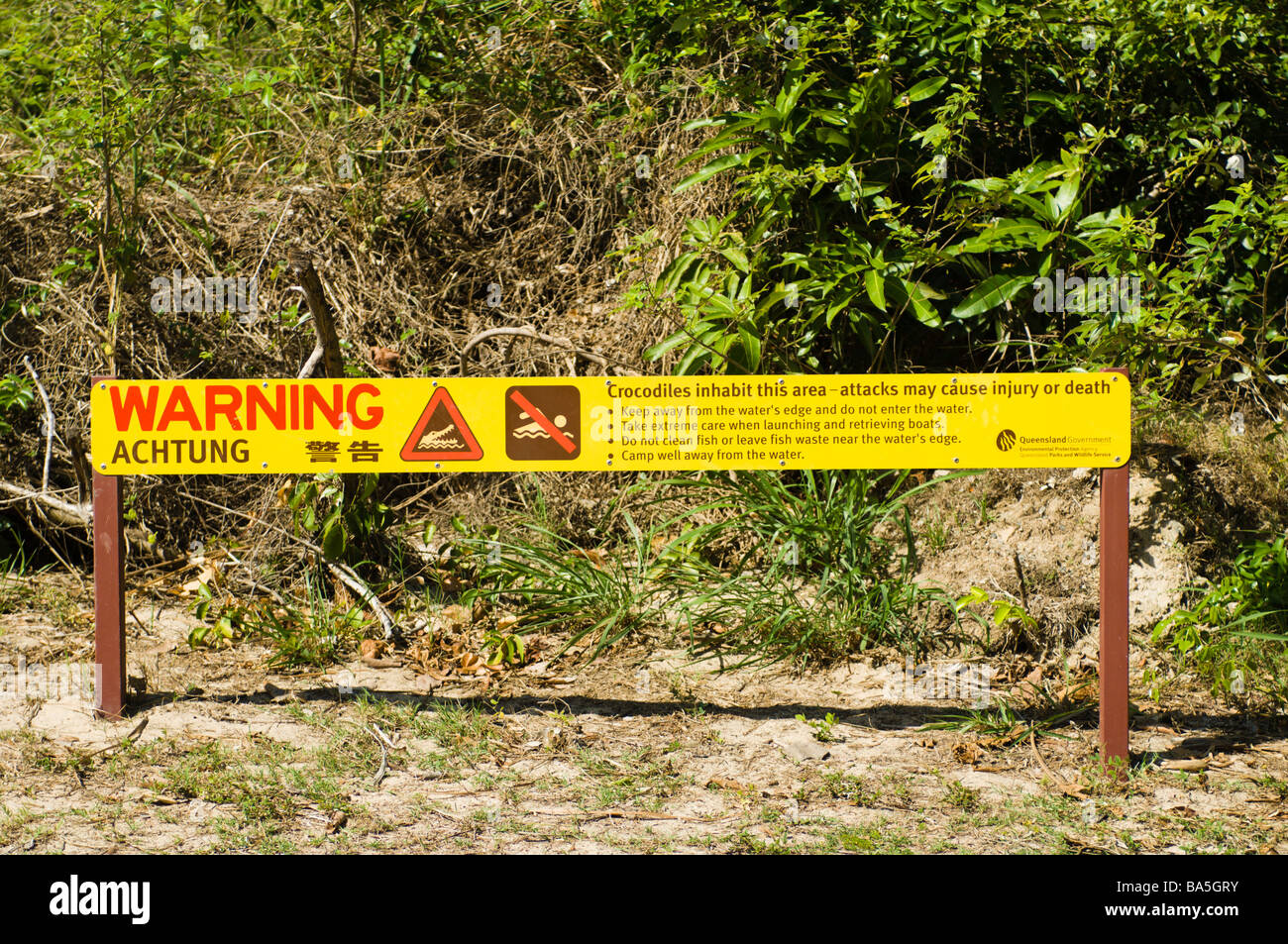 Crocodile warning sign on the beach at Port Douglas Stock Photo