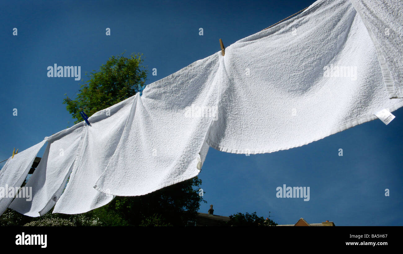 A row of Terry nappies drying on a clothes line Stock Photo