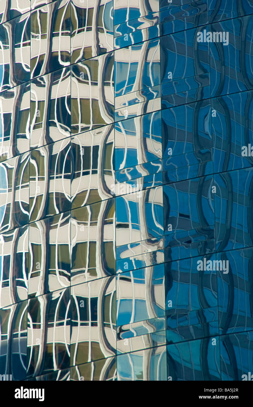 Patterns of distortion reflected from the glass facade of a high-rise ...