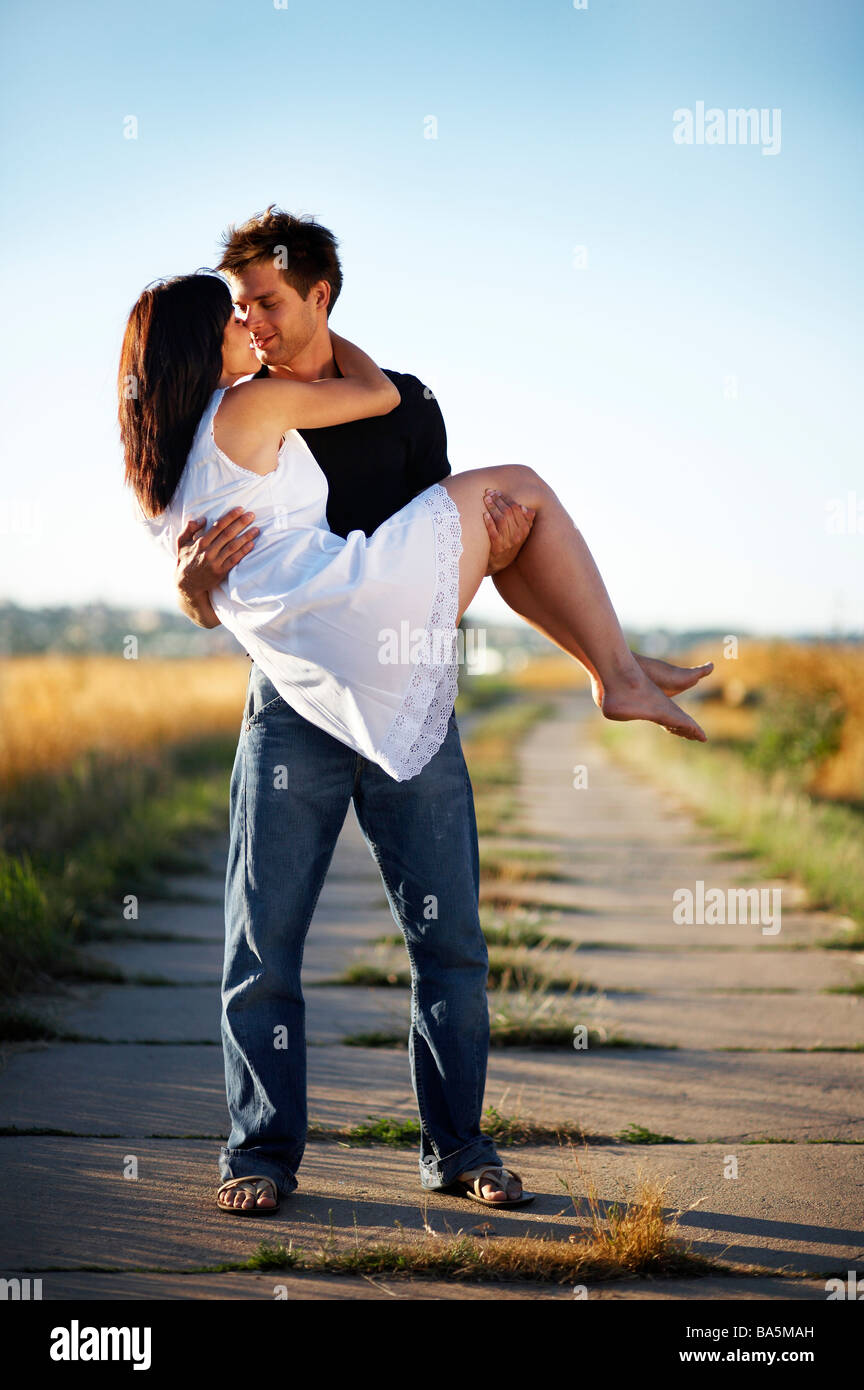 Lady carrying man in her arms