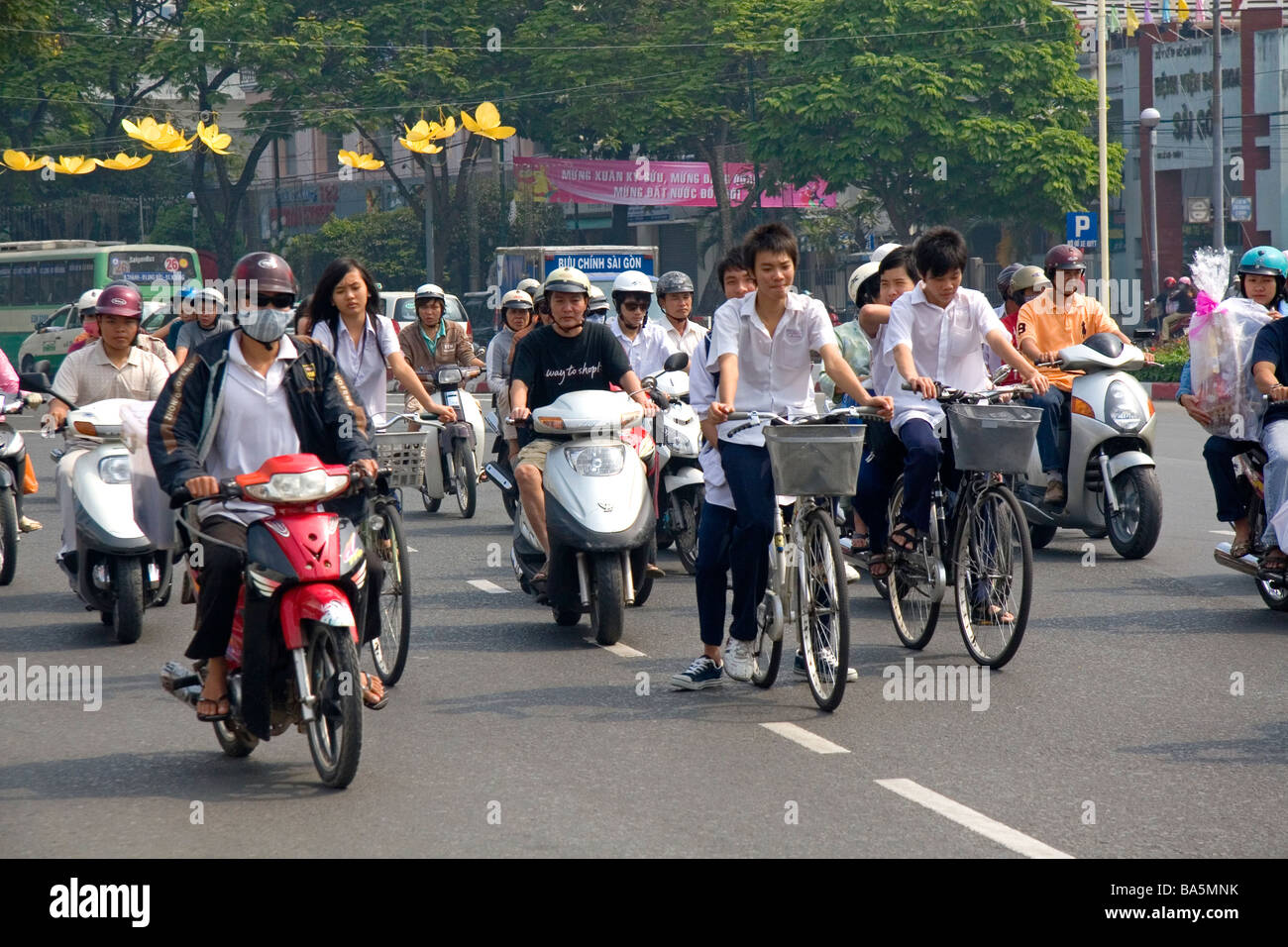 Vietnamese people ride bicycles and motorbikes in Ho Chi Minh City