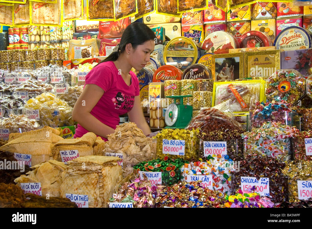 Female vendor selling treats in the Ben Thanh Market located in Ho Chi Minh City Vietnam Stock Photo