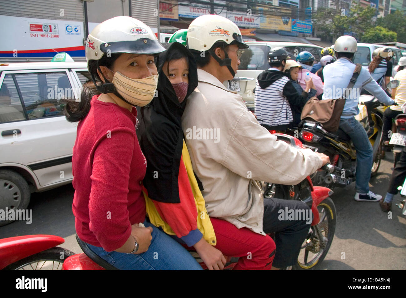 Vietnamese family riding a motorbike in Ho Chi Minh City Vietnam Stock Photo
