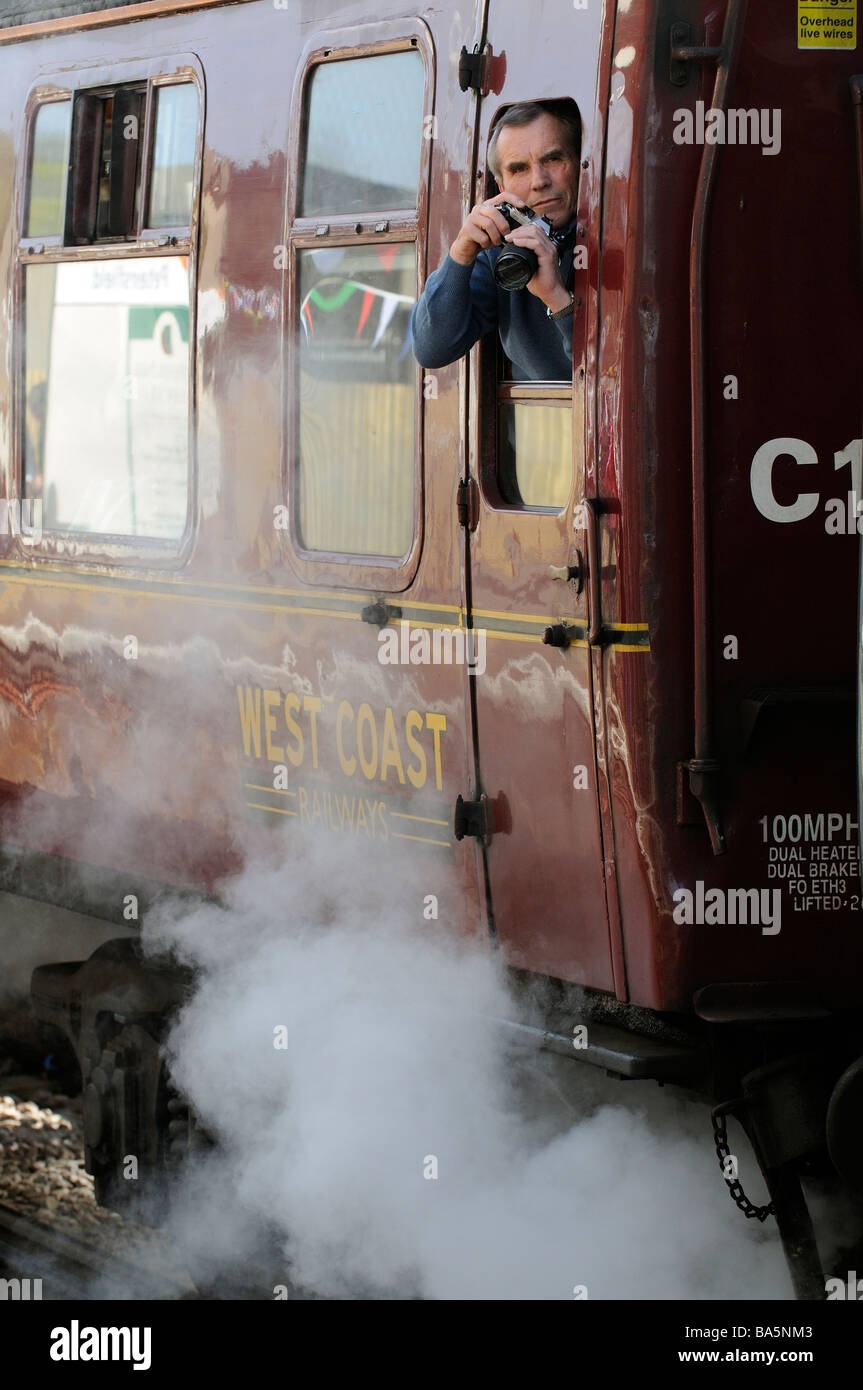 photo railway enthusiast taking photos from an old West Coast Railways railway carriage Stock Photo