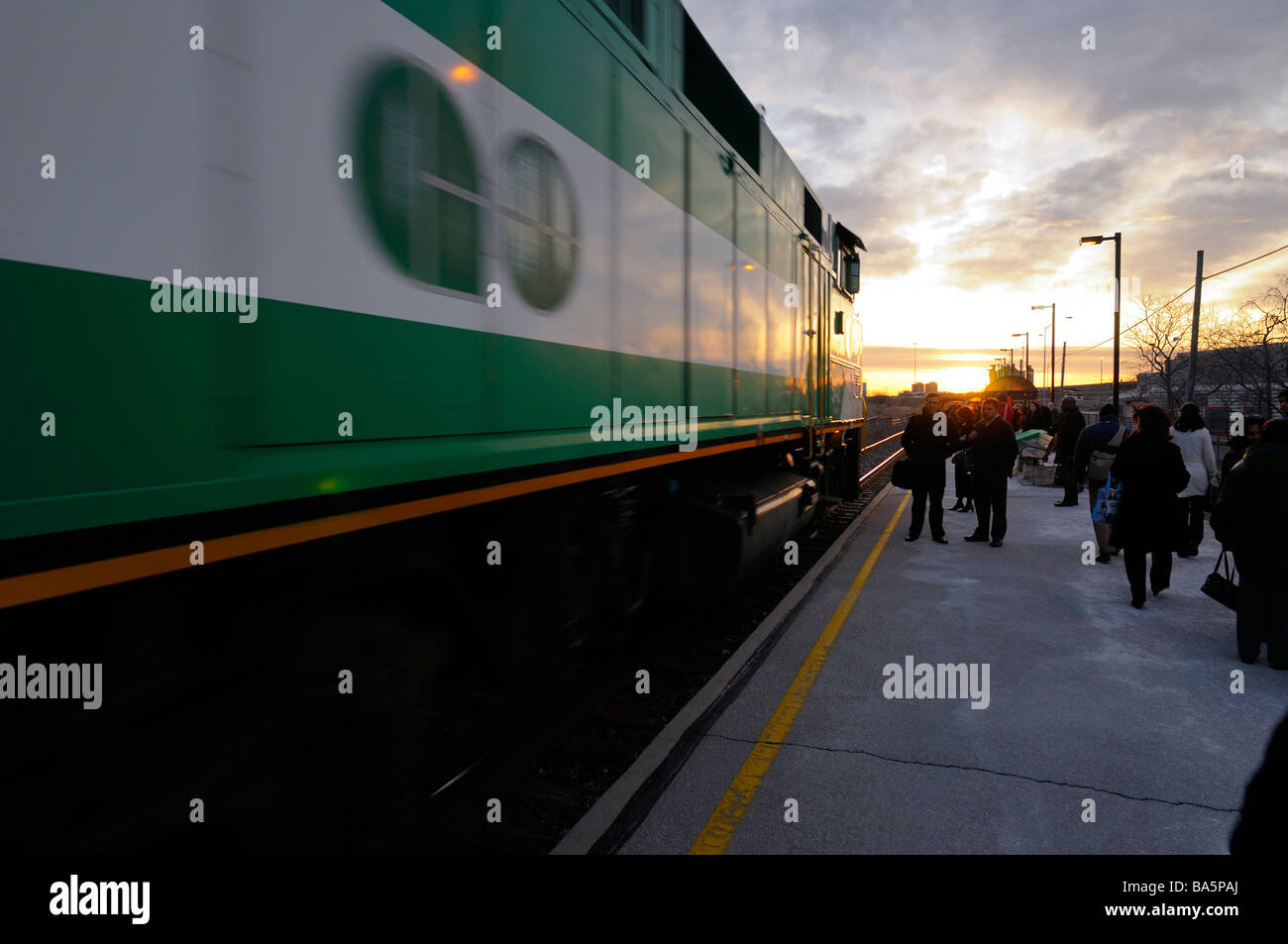 Government of Ontario GO commuter train arriving at station on a workday morning at sunrise Toronto Stock Photo