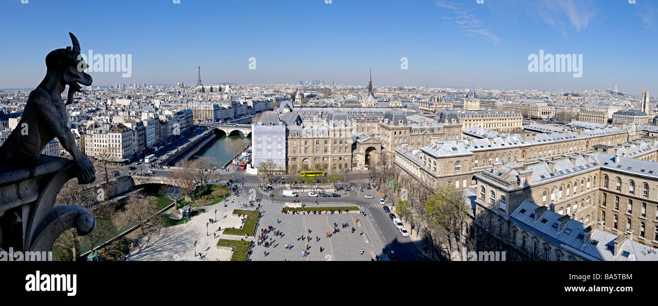 Panoramic view of Paris skyline from the top of Notre Dame de Paris cathedral, with one of the cathedral's distinctive gargoyles Stock Photo