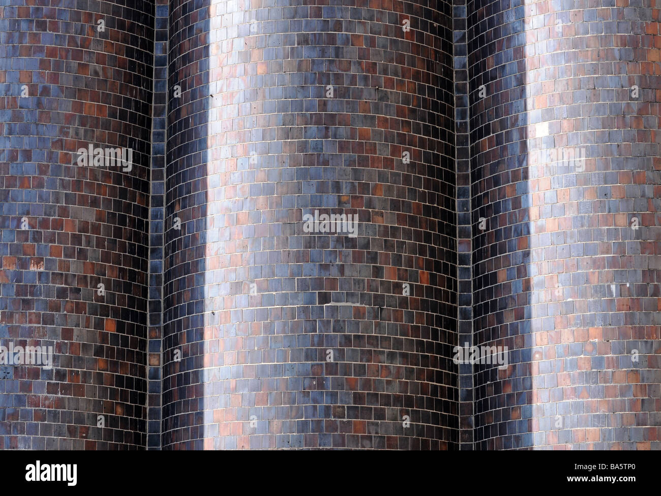 Multi coloured tiles, shingles, scales on a chimney stack in an industrialized zone. Beautiful urban architecture. Stock Photo