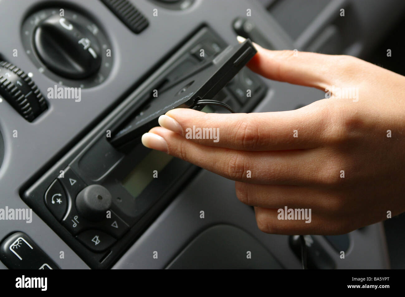 Car indoors woman hand adapter-cassette car radio cassette-shaft puts in  detail no property release vehicle Autofahren cockpit Stock Photo - Alamy