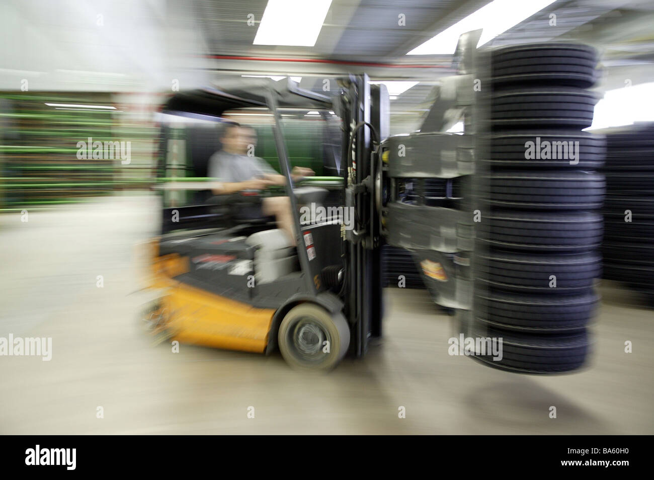 Tire-factory work-hall camps workers forklifts fuzziness no property release economy industry tires automobile-industry Stock Photo