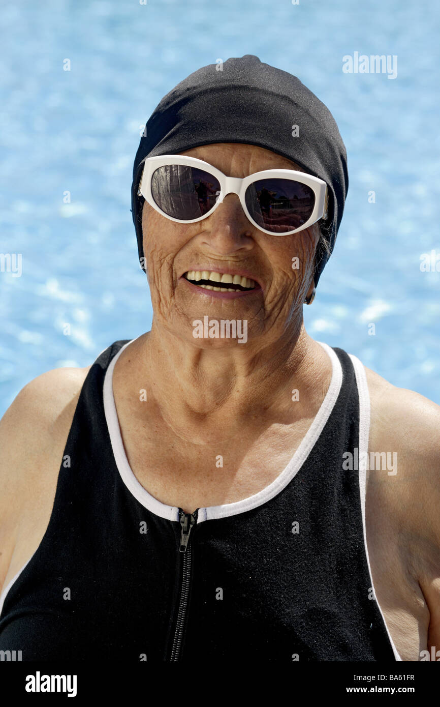Pool senior swimsuit bath-cap sun glass laughs semi-portrait series people  seniors woman 70-80 years gaze camera cheerfully Stock Photo - Alamy
