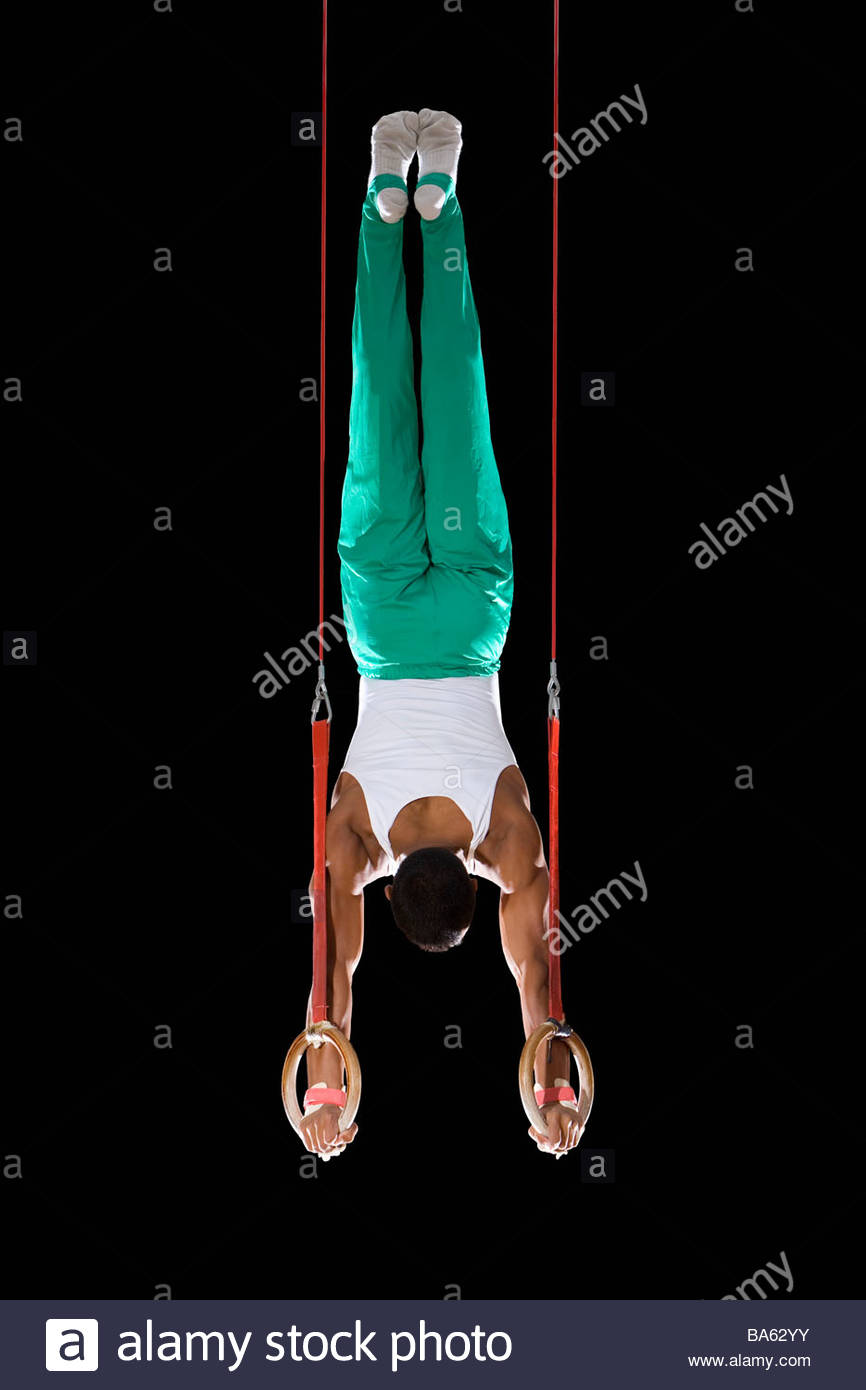Male Gymnast Performing On Rings Stock Photos & Male Gymnast Performing