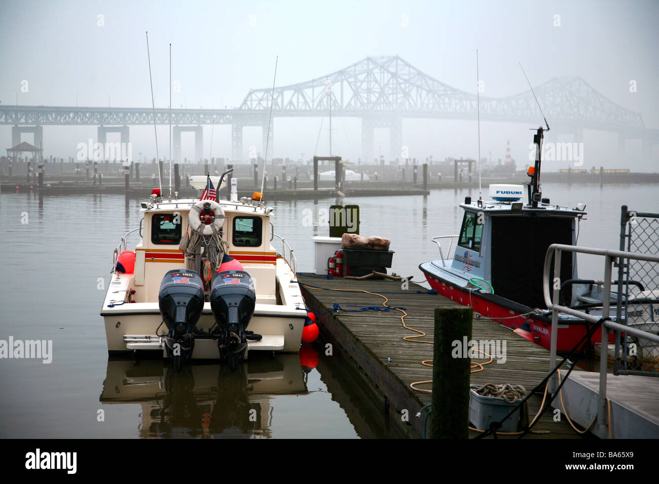 Boat docked in marina on the Hudson River, foggy Tappan Zee Bridge in the background, Tarrytown, NY, USA Stock Photo
