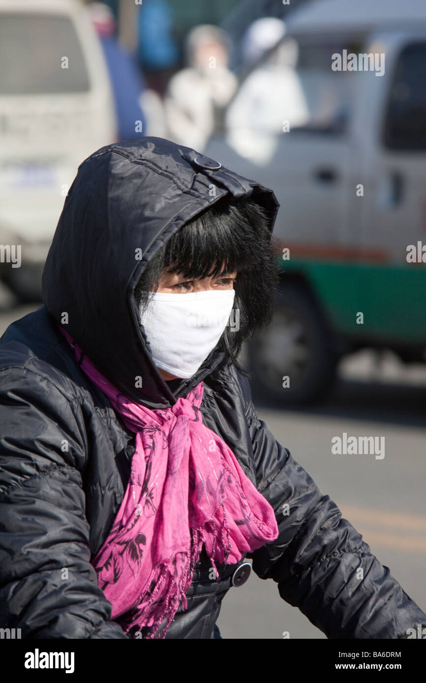 A woman wearing a face mask to combat the awful air pollution in Suihua  city in Northern China Stock Photo - Alamy