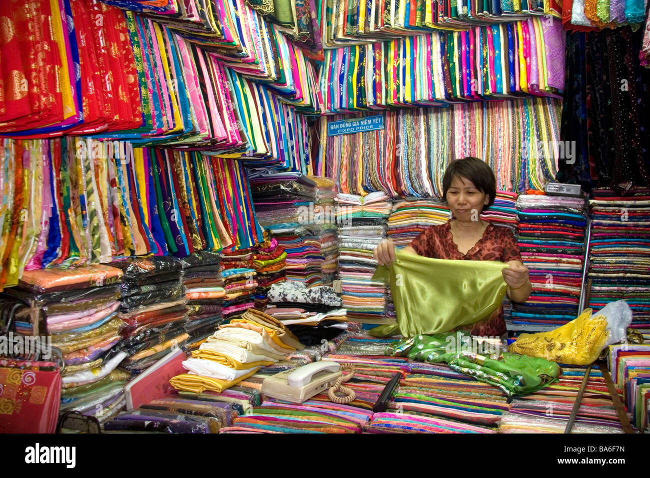 Vendors selling silk fabric in the Ben Thanh Market located in Ho Chi Minh City Vietnam Stock Photo
