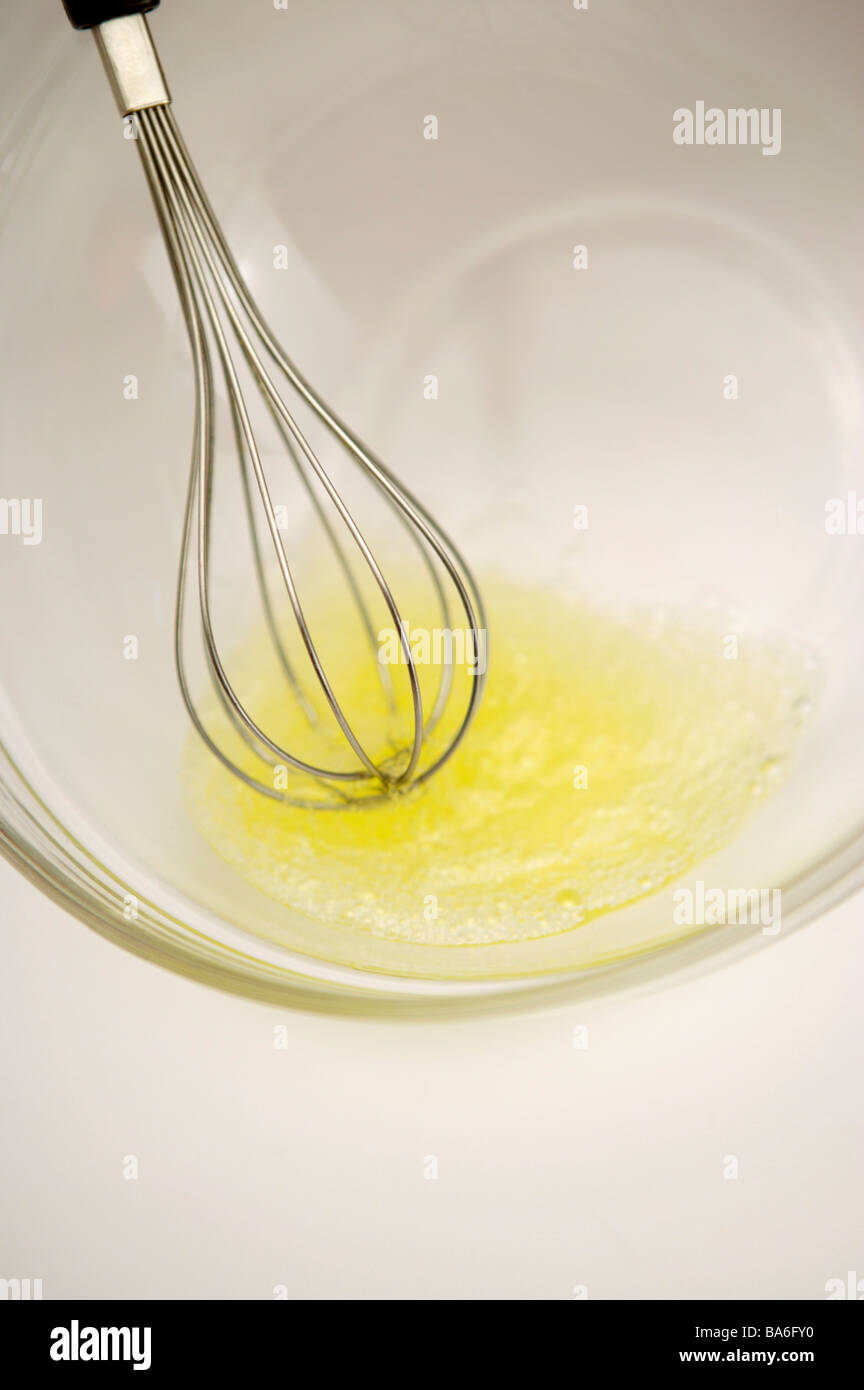 Egg whisk egg yolk and bowl Stock Photo Alamy