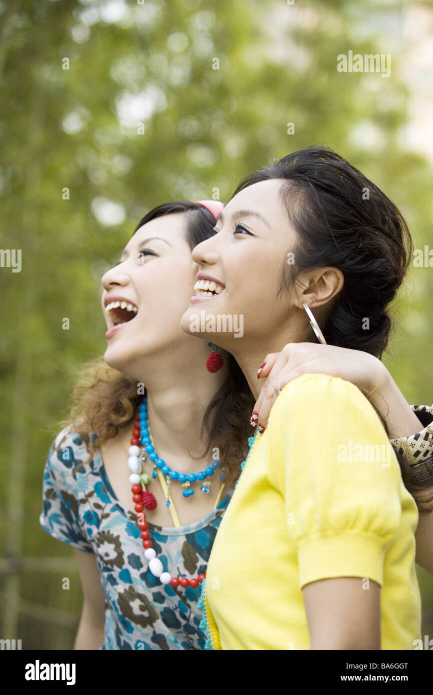 Two young women smiling outdoors portrait Stock Photo - Alamy
