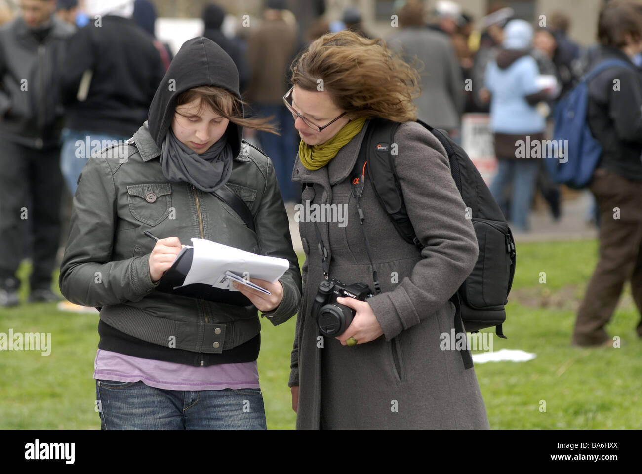 A volunteer right collects signatures on a petition in Battery Park in New York Stock Photo